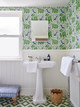 Bathroom featuring La Jungle vinyl wallpaper in Grass, a Raoul Dufy–inspired design. Interior design by LHA Designs, photography by Nick Smith.